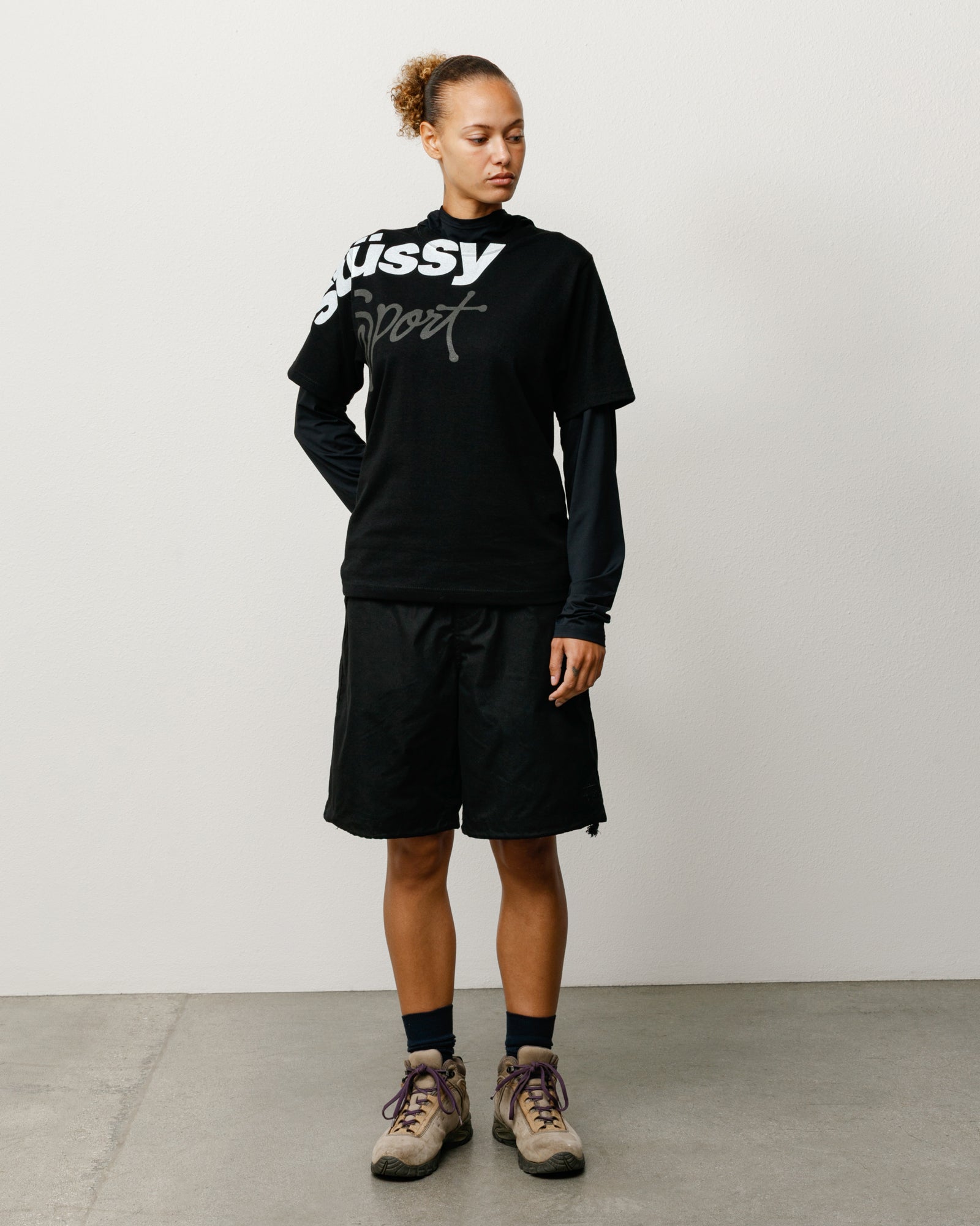 Surplus Short in Black, baggy cotton-nylon short on model with drawcord waist