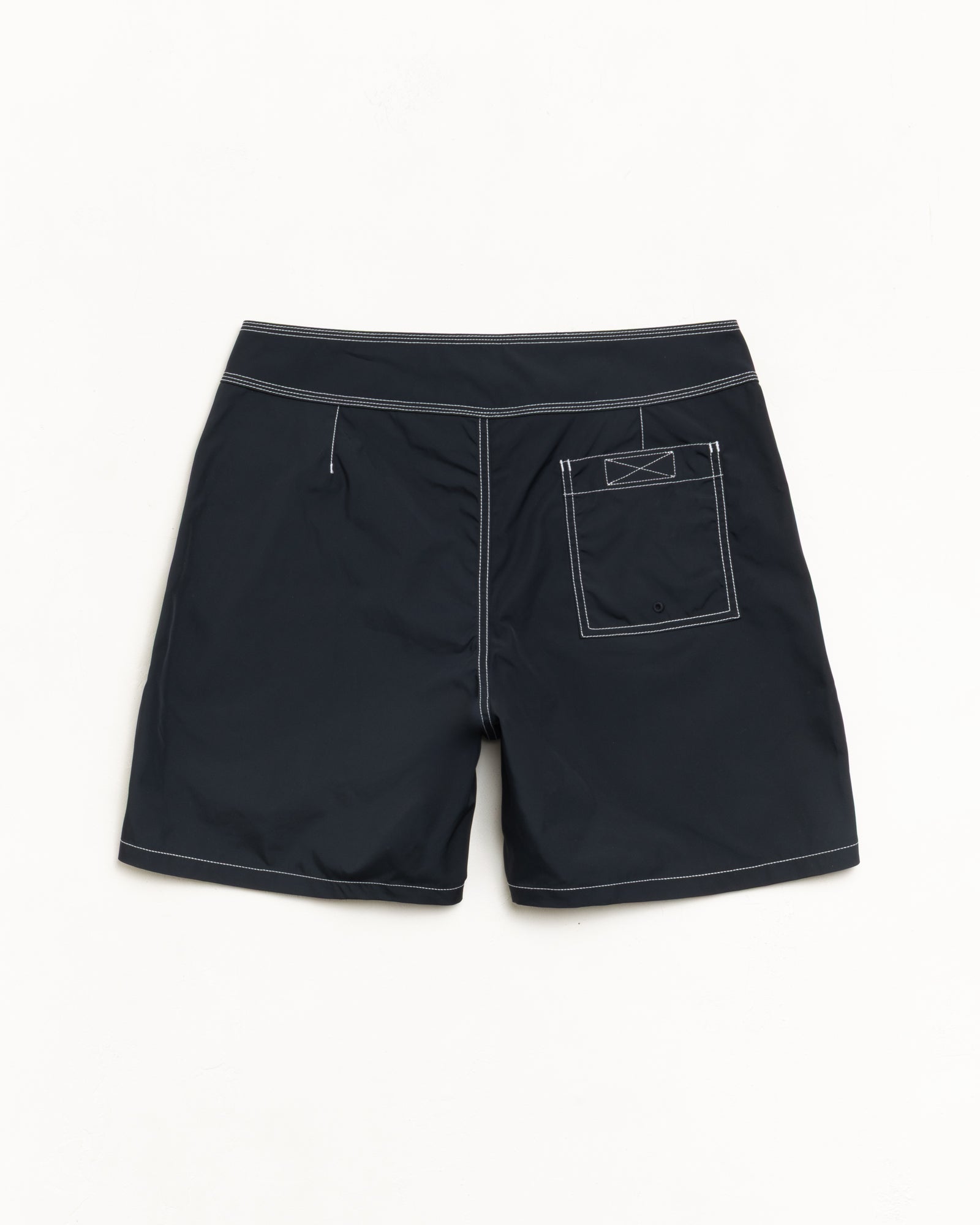 Coastal Board Short in Black, back flat with contrast stitching and a rear patch pocket