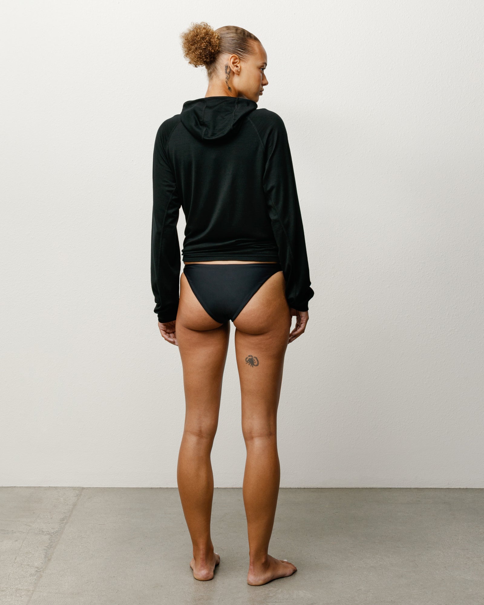 Bikini Bottom Swim in the color Black featuring a mid-rise waist and Stüssy branding.