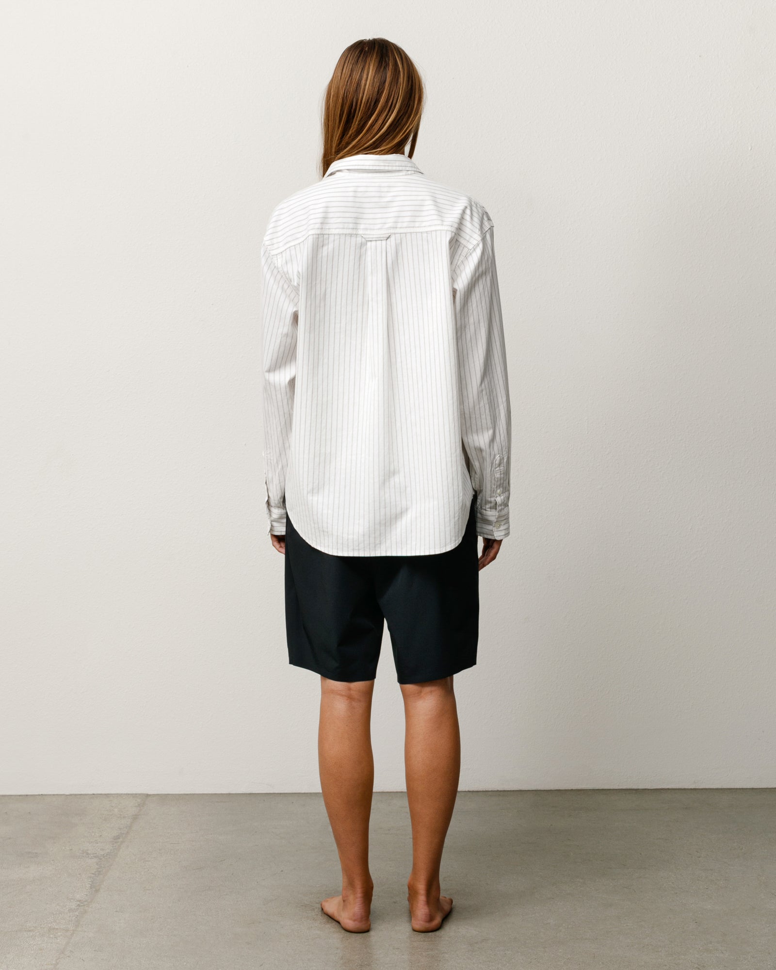 Stüssy Peak Board Short in black, unisex stretch-nylon boardshorts shown on model, back view.