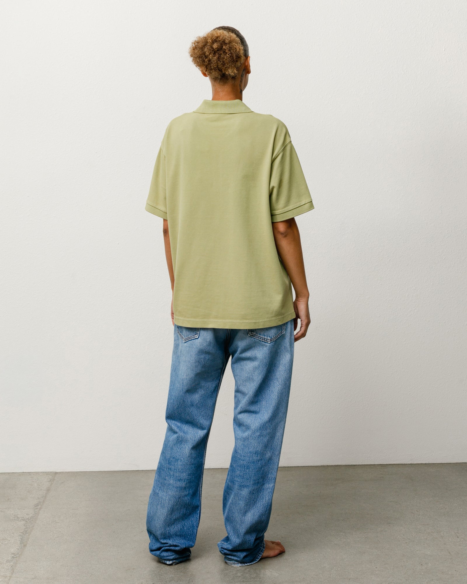 Classic Pique Polo in Leaf green, unisex short-sleeve, back view on model