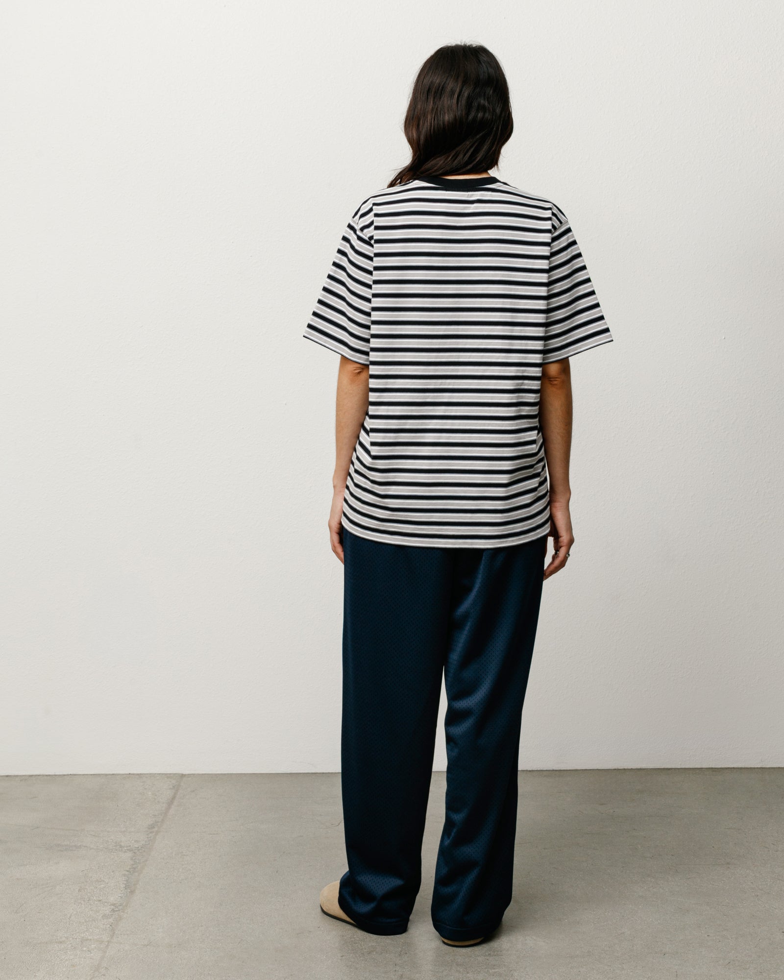 Beach Stripe Tee in Black, back view on model with black and white stripes.