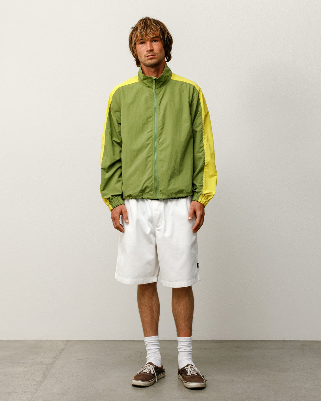 Man wearing a green LIGHTWEIGHT MOCK JACKET with white shorts on a plain background.
