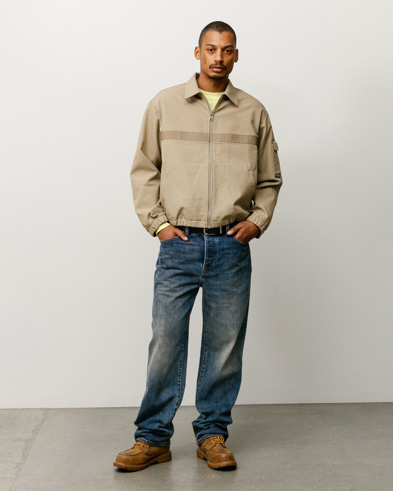 Mechanic Jacket outerwear in khaki, on-body look with zip front, elastic hem, and tonal chest stripe.