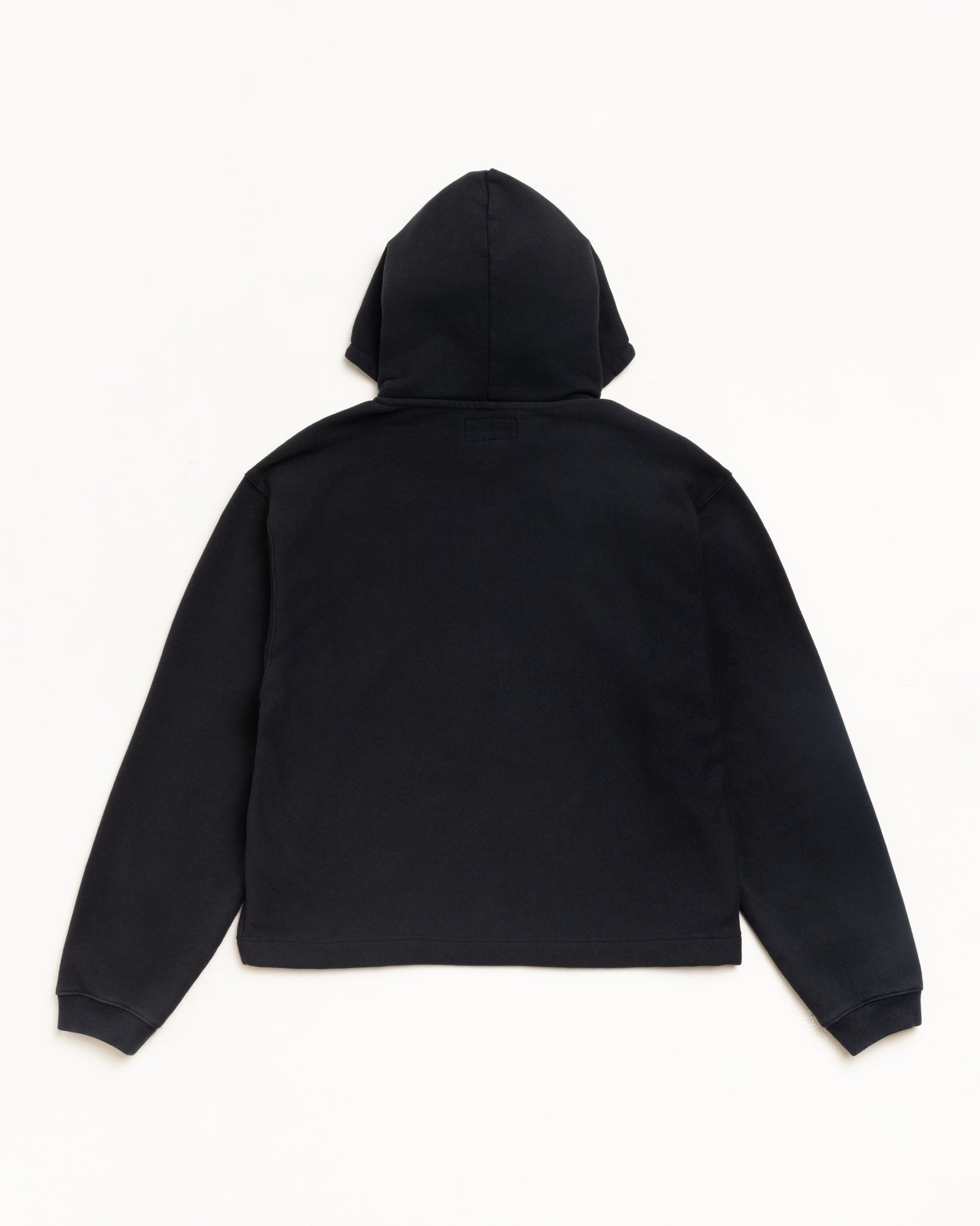 Oval Pullover Hoodie in Black, back view, fleece with ribbed cuffs and attached hood
