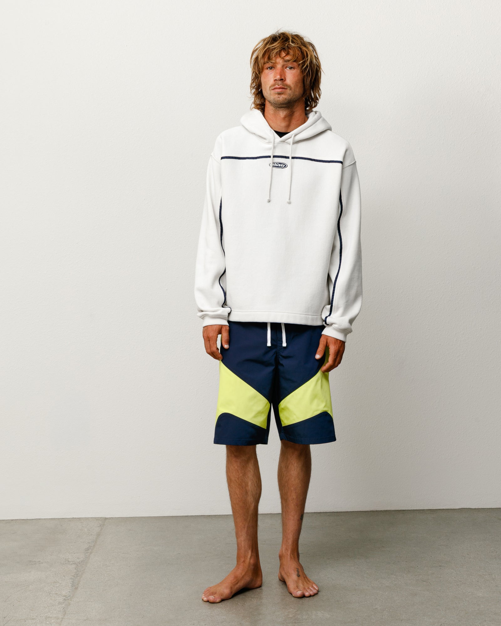 Oval Pullover Hoodie in Stone with contrast piping, drawcord hood, and ribbed cuffs.