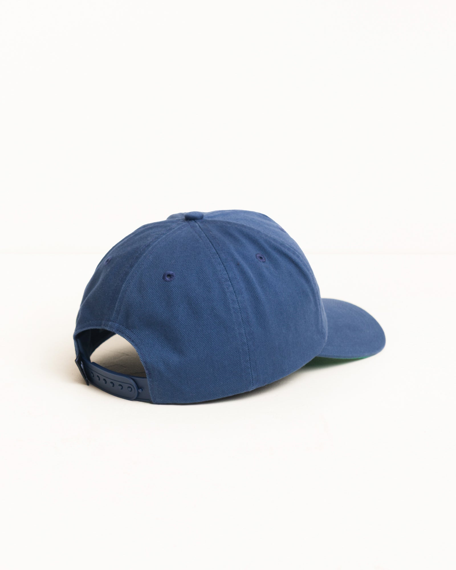 Big Stock Snapback Cap in Deep Blue, mid-depth five panel washed cotton with snapback closure and green undervisor